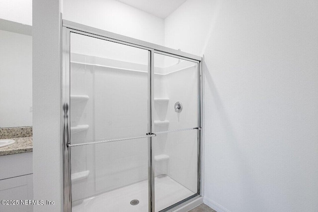 bathroom with vanity and a shower with shower door