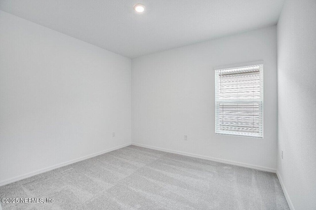 spare room with light colored carpet