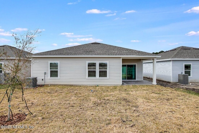 back of house featuring a lawn and central air condition unit