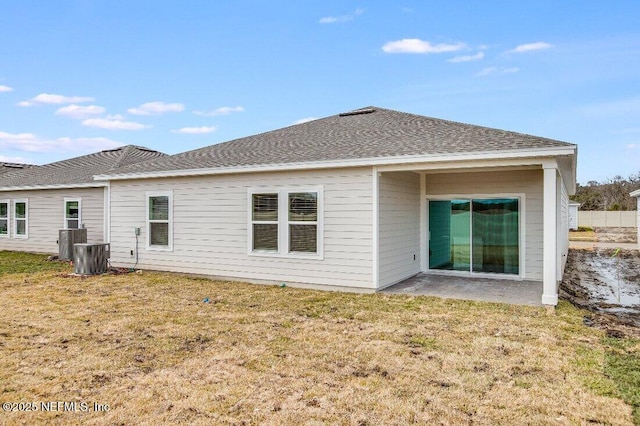 back of house featuring a yard, central AC unit, and a patio area