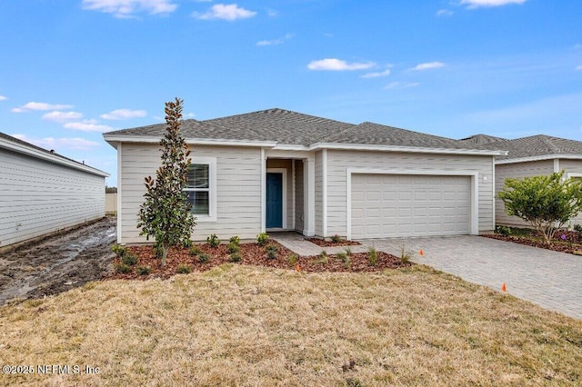 view of front facade with a garage and a front yard