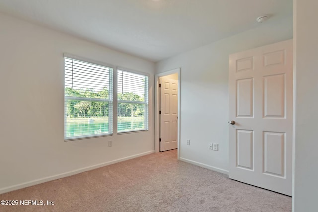 unfurnished bedroom featuring light carpet