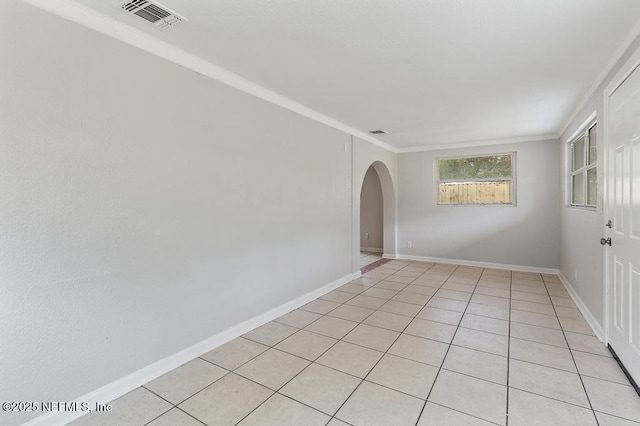 tiled spare room with ornamental molding