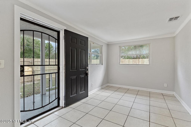 tiled entrance foyer with ornamental molding