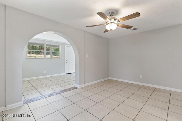 spare room featuring ceiling fan and light tile patterned floors