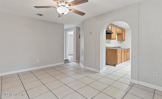 tiled empty room with ceiling fan