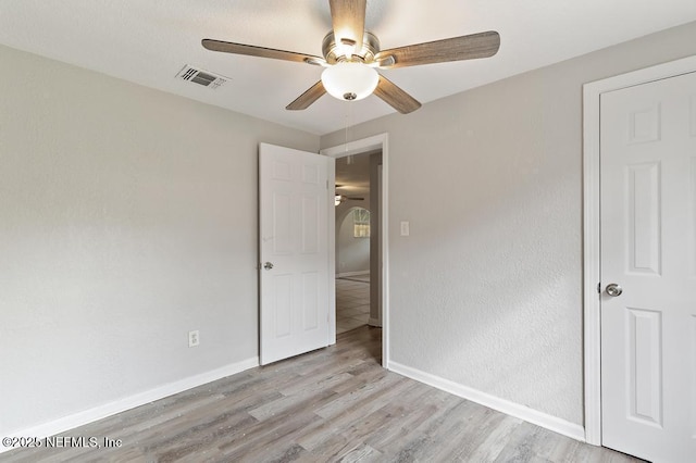 unfurnished bedroom featuring light wood-type flooring and ceiling fan