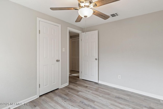 unfurnished bedroom with ceiling fan and light wood-type flooring