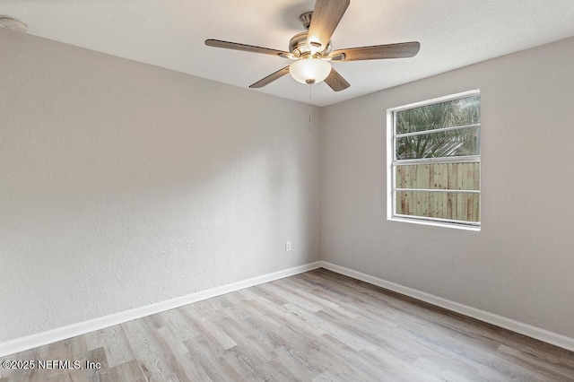 spare room featuring ceiling fan and light hardwood / wood-style flooring