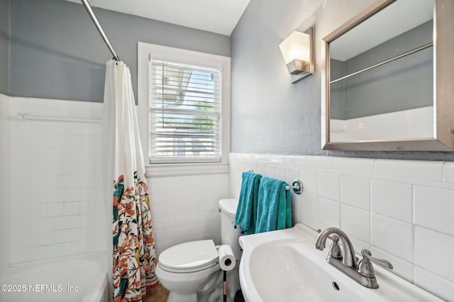 full bathroom featuring sink, shower / tub combo, tile walls, and toilet