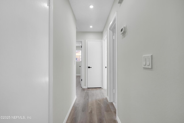 hallway with light hardwood / wood-style floors