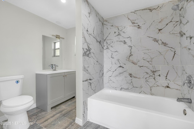 full bathroom featuring toilet, vanity, and washtub / shower combination