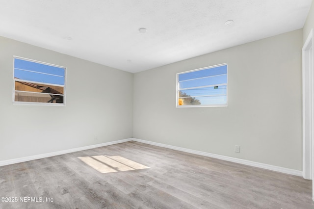 spare room featuring light hardwood / wood-style floors