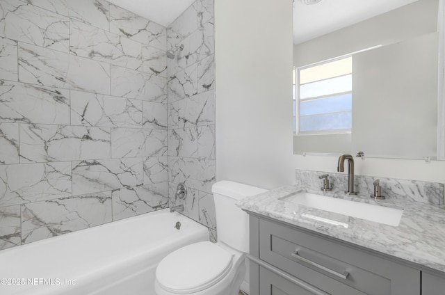 full bathroom with vanity, toilet, and tiled shower / bath