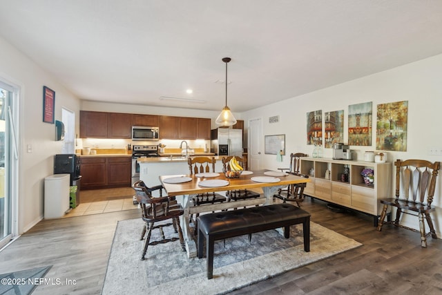 dining space featuring dark hardwood / wood-style floors and sink