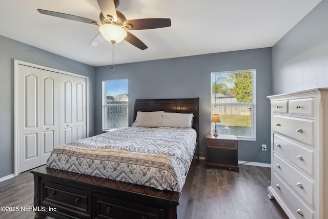 bedroom with dark hardwood / wood-style flooring, a closet, and ceiling fan