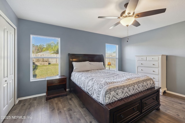 bedroom featuring dark hardwood / wood-style flooring, a closet, and ceiling fan