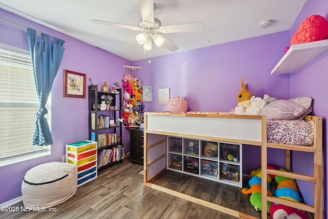 bedroom with wood-type flooring, a textured ceiling, and ceiling fan