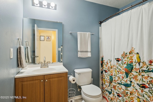 bathroom with curtained shower, vanity, a textured ceiling, and toilet