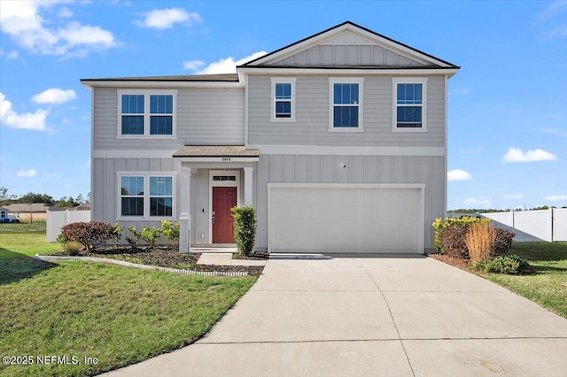 view of property featuring a front yard and a garage