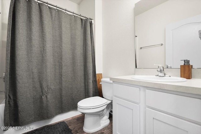 bathroom featuring hardwood / wood-style flooring, vanity, and toilet