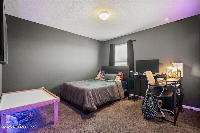 bedroom featuring carpet floors and a textured ceiling