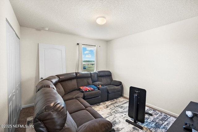 living room featuring a textured ceiling and light colored carpet