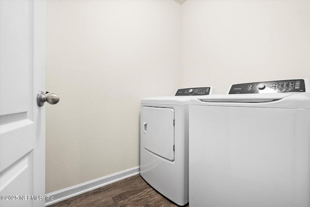 laundry area featuring dark hardwood / wood-style flooring and washing machine and dryer