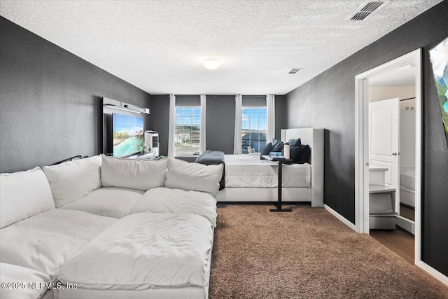 carpeted bedroom featuring a textured ceiling