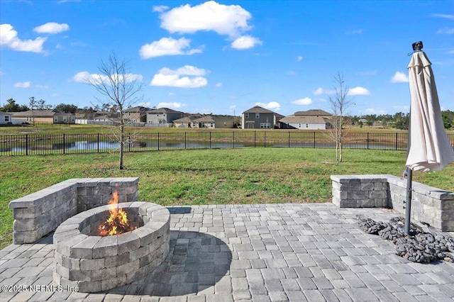 view of patio / terrace featuring a water view and an outdoor fire pit