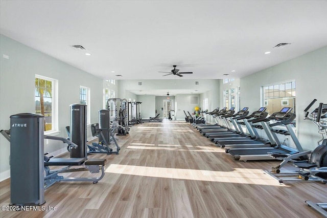 exercise room featuring light wood-type flooring and ceiling fan