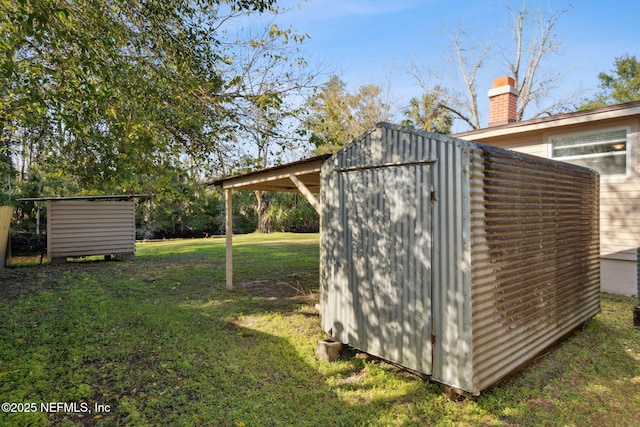 view of outdoor structure featuring a yard