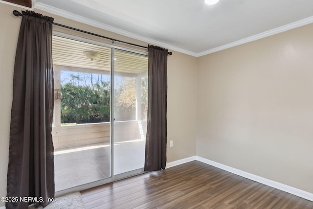 empty room with crown molding and hardwood / wood-style floors