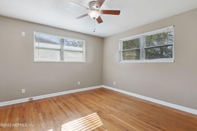 spare room with ceiling fan, plenty of natural light, and light hardwood / wood-style floors