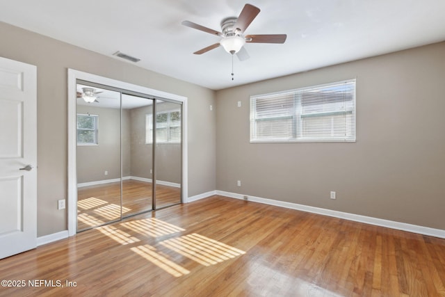 unfurnished bedroom with a closet, ceiling fan, and hardwood / wood-style flooring