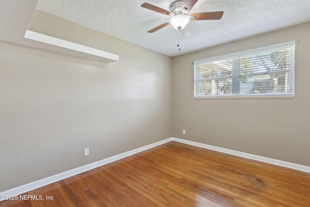 unfurnished room featuring hardwood / wood-style floors, ceiling fan, and a textured ceiling