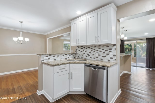 kitchen with dishwasher, decorative backsplash, white cabinetry, and sink