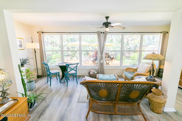 sunroom featuring ceiling fan