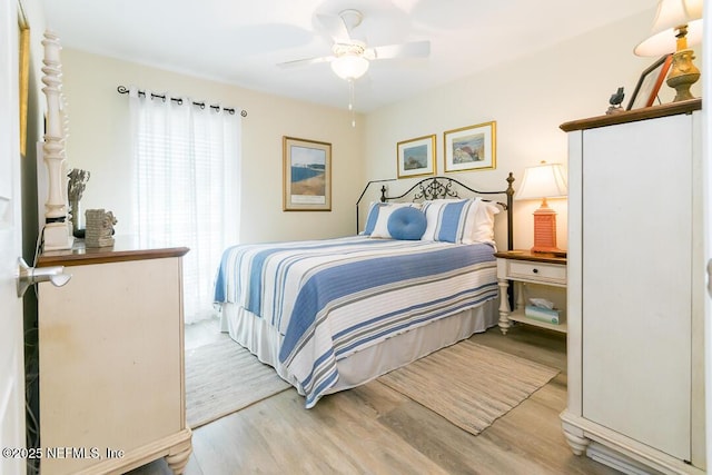 bedroom with ceiling fan and wood-type flooring