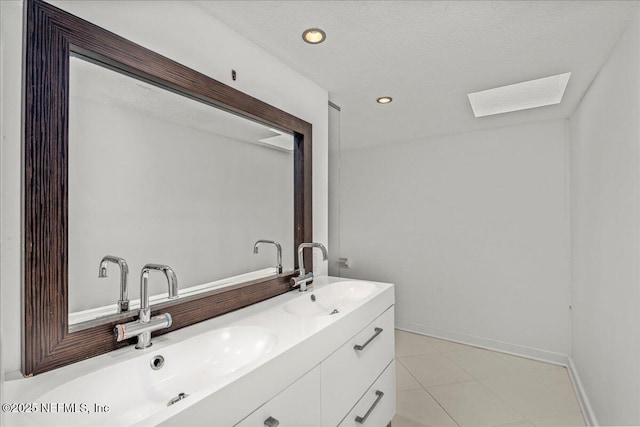 bathroom with a textured ceiling and vanity