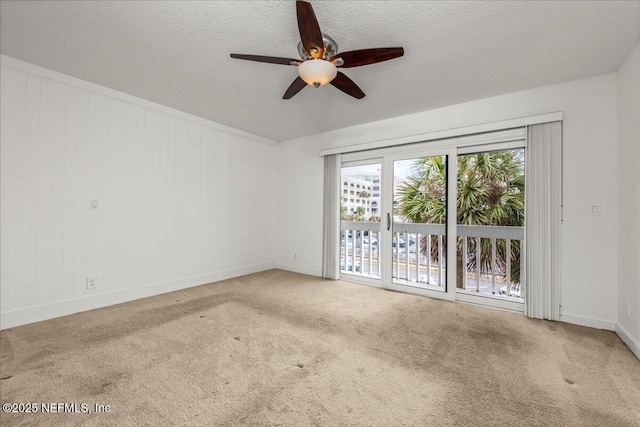 carpeted empty room with a textured ceiling and ceiling fan