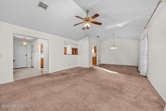 unfurnished living room with a textured ceiling, ceiling fan with notable chandelier, light colored carpet, and vaulted ceiling