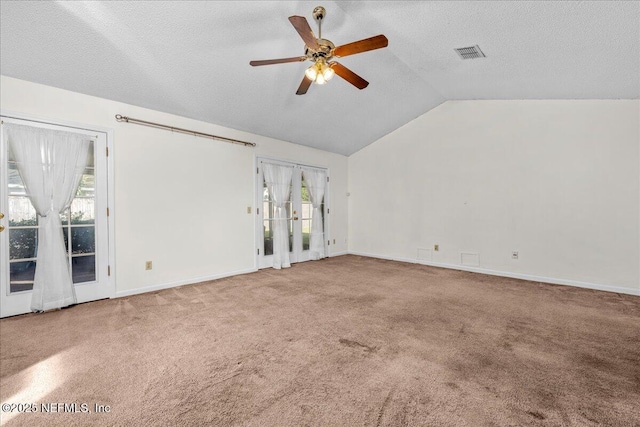 unfurnished living room with carpet, plenty of natural light, lofted ceiling, and ceiling fan