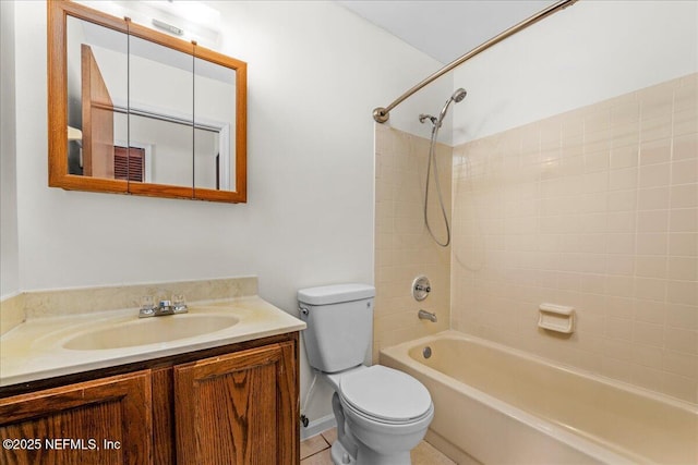 full bathroom featuring tile patterned floors, toilet, vanity, and tiled shower / bath