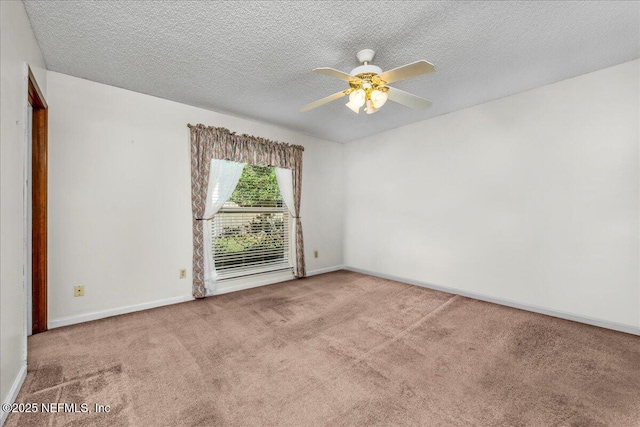 spare room featuring carpet flooring, ceiling fan, and a textured ceiling