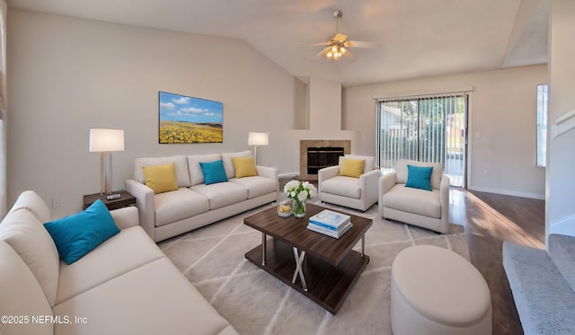 living room with ceiling fan, light hardwood / wood-style floors, and lofted ceiling