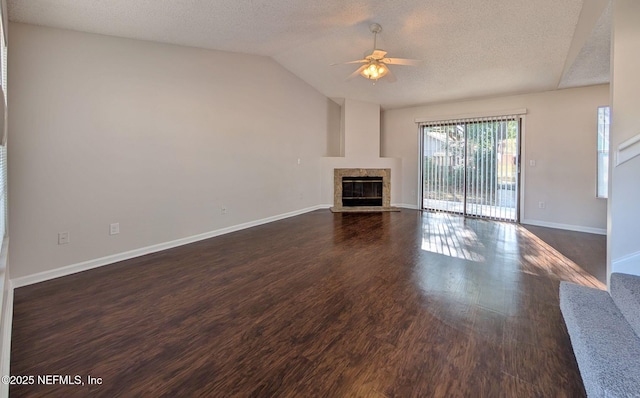 unfurnished living room featuring a textured ceiling, a premium fireplace, ceiling fan, and vaulted ceiling