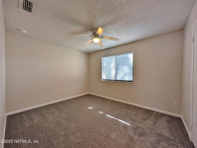 unfurnished room featuring ceiling fan, dark carpet, and a textured ceiling