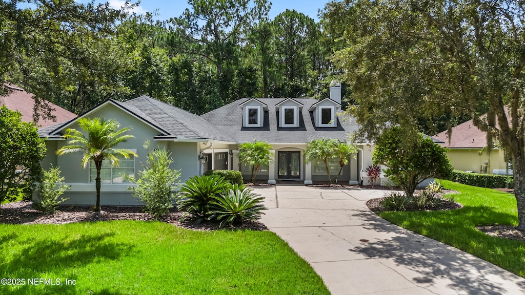 cape cod home with a front yard