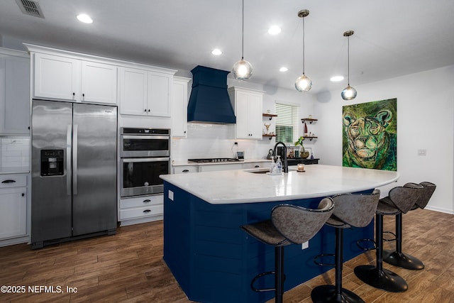 95220 Snapdragon Dr, Fernandina Beach, FL 32034 - kitchen featuring custom exhaust hood, appliances with stainless steel finishes, a sink, dark wood-style floors, and visible vents